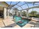 Beautiful pool with a jacuzzi and tanning ledge in a screened-in lanai, providing an outdoor oasis at 5405 Tybee Island Dr, Apollo Beach, FL 33572