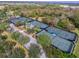 Aerial view of community tennis courts surrounded by lush landscaping and mature trees at 5405 Tybee Island Dr, Apollo Beach, FL 33572