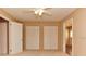 Bedroom featuring neutral walls, ceiling fan and multiple closets at 5521 80Th N St # 110, St Petersburg, FL 33709