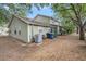 Backyard view of a light green home featuring mature landscaping at 602 Lynchburg Dr, Brandon, FL 33511