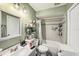 Neutral-toned bathroom with shower-tub combination, decorated with modern fixtures and accessories at 602 Lynchburg Dr, Brandon, FL 33511