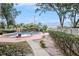 Outdoor community swimming pool with pergola, lounge area, mature trees, and ample space for entertaining at 602 Lynchburg Dr, Brandon, FL 33511