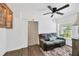 Cozy bedroom with a gray loveseat, accent rug, modern ceiling fan and a charming barn door at 607 Carolyn Dr, Brandon, FL 33510