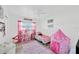 Bright bedroom with pink accents, a large window and a playful atmosphere at 607 Carolyn Dr, Brandon, FL 33510