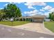 Attractive single-story home with mature landscaping, long driveway, and convenient carport at 607 Carolyn Dr, Brandon, FL 33510
