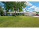 Attractive single-story home with mature landscaping, long driveway, and convenient carport at 607 Carolyn Dr, Brandon, FL 33510