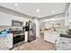 Bright kitchen featuring stainless steel appliances, white cabinets, and wood flooring at 607 Carolyn Dr, Brandon, FL 33510