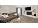 Inviting living room with a comfortable leather sofa, fireplace, and wood flooring at 607 Carolyn Dr, Brandon, FL 33510