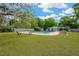 Inviting community pool surrounded by a lush green lawn with ample seating for relaxation and enjoyment at 607 Carolyn Dr, Brandon, FL 33510