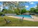 Refreshing community pool surrounded by a lush green lawn with ample seating for relaxation and enjoyment at 607 Carolyn Dr, Brandon, FL 33510