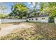 Well-sized backyard featuring a patio, full perimeter fence, mature trees, and a grassy area at 7012 S Trask St, Tampa, FL 33616