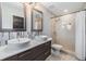Modern bathroom with dual vessel sinks, stylish mirrors, tiled shower with glass door at 7012 S Trask St, Tampa, FL 33616