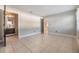 Large bedroom with tiled flooring, neutral walls, and ensuite bathroom at 7012 S Trask St, Tampa, FL 33616