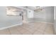 Dining area next to the kitchen features tile floors and a decorative light fixture at 7012 S Trask St, Tampa, FL 33616