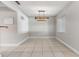 Dining room featuring tile flooring, natural light, and a contemporary light fixture at 7012 S Trask St, Tampa, FL 33616