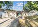 Charming single-story home with a well-manicured lawn, blue front door, and a two-car garage at 7012 S Trask St, Tampa, FL 33616
