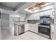 Bright kitchen with white cabinets, stainless steel appliances, and a decorative backsplash at 7012 S Trask St, Tampa, FL 33616