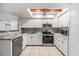 Modern kitchen with white cabinets, stainless steel appliances, and granite countertops at 7012 S Trask St, Tampa, FL 33616