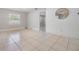 Spacious living area featuring tile floors, white brick accents, and ample natural light from the window at 7012 S Trask St, Tampa, FL 33616