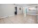 Bright living room with tile flooring and neutral paint, seamlessly connecting to the kitchen at 7012 S Trask St, Tampa, FL 33616