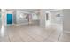 Open-concept living area with tile floors, leading to a dining space and modern kitchen at 7012 S Trask St, Tampa, FL 33616
