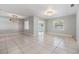 Bright living room with neutral tile flooring, a modern light fixture, and natural light at 7012 S Trask St, Tampa, FL 33616