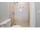 Close-up of the tiled shower with modern shower head and floral accents at 7012 S Trask St, Tampa, FL 33616