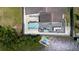 Aerial view of backyard with hot tub, deck, and dock with kayaks and paddle boards at 7404 Bay Dr, Tampa, FL 33635
