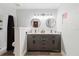 This bathroom includes a dual sink, shower, and gray cabinets with a white countertop at 7404 Bay Dr, Tampa, FL 33635