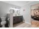 This bathroom includes a dual sink, shower, and gray cabinets with a white countertop at 7404 Bay Dr, Tampa, FL 33635