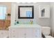 Bright bathroom featuring tiled walls, modern fixtures, a light countertop, and a mirror that amplifies the natural light at 7404 Bay Dr, Tampa, FL 33635