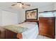 This bedroom features light wood floors, a modern ceiling fan, and a dresser with an aquarium at 7404 Bay Dr, Tampa, FL 33635