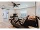 This bedroom includes light wood floors, a modern ceiling fan, and a small desk area at 7404 Bay Dr, Tampa, FL 33635