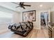 Cozy bedroom features unique decor, wood-look floors, and an open doorway to the stairway, blending comfort and style at 7404 Bay Dr, Tampa, FL 33635