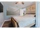 A light-filled bedroom boasts a ceiling fan, and a large world map wall decoration at 7404 Bay Dr, Tampa, FL 33635