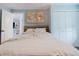Comfortable bedroom with a full size bed, closet and world map wall decoration at 7404 Bay Dr, Tampa, FL 33635