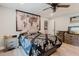 This bedroom includes wood-look flooring, a ceiling fan, and gray wood bedroom furniture at 7404 Bay Dr, Tampa, FL 33635