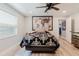 This bedroom features wood-look floors, a modern ceiling fan, and a unique map wall decor at 7404 Bay Dr, Tampa, FL 33635