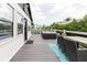 Large deck with outdoor seating and dining area at 7404 Bay Dr, Tampa, FL 33635