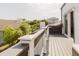 Spacious outdoor deck featuring wood-look flooring and ample space for relaxing, plus a white railing and views of the neighborhood at 7404 Bay Dr, Tampa, FL 33635
