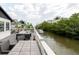 Back deck with dining and seating overlooking canal at 7404 Bay Dr, Tampa, FL 33635