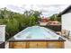 Exterior shot of a wooden hot tub with jets, surrounded by trees at 7404 Bay Dr, Tampa, FL 33635