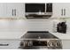 Close-up of the kitchen with modern appliances and white cabinets, highlighting the functional and stylish design at 7404 Bay Dr, Tampa, FL 33635