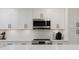 Bright kitchen features white cabinets, stainless steel appliances, and a stylish subway tile backsplash at 7404 Bay Dr, Tampa, FL 33635