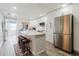 Modern kitchen with white cabinets, a spacious island, and stainless steel appliances, providing a sleek and functional design at 7404 Bay Dr, Tampa, FL 33635