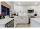 Kitchen features white cabinets, quartz countertops, stainless steel appliances, and subway tile backsplash at 7404 Bay Dr, Tampa, FL 33635