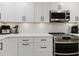 Well-equipped kitchen with white cabinets, modern appliances, and ample counter space, ideal for cooking and meal preparation at 7404 Bay Dr, Tampa, FL 33635