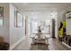 Well-lit living area with wood floors, a dining table, and views of the kitchen, creating a cozy atmosphere at 7404 Bay Dr, Tampa, FL 33635