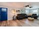 Warm living room with wood floors, leather sectional, and elegant lighting at 7404 Bay Dr, Tampa, FL 33635