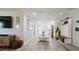 Bright living area featuring wood floors, a dining table, and access to the kitchen, ideal for Gathering gatherings at 7404 Bay Dr, Tampa, FL 33635